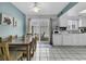 Open-concept kitchen with white cabinets, dining area, and sliding glass doors to the patio at 405 N Hillside Dr. N # C3, North Myrtle Beach, SC 29582