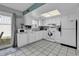 Bright kitchen features white cabinetry, tile floors, and access to the outdoor patio at 405 N Hillside Dr. N # C3, North Myrtle Beach, SC 29582