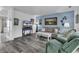 Bright living room with light blue wall, TV, gray wood floors, and comfortable seating at 405 N Hillside Dr. N # C3, North Myrtle Beach, SC 29582