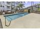 Community pool with clear blue water, surrounded by fencing and mature trees at 405 N Hillside Dr. N # C3, North Myrtle Beach, SC 29582
