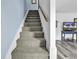 Carpeted stairs lead to the upper level, next to the living room area at 405 N Hillside Dr. N # C3, North Myrtle Beach, SC 29582