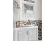 Updated bathroom features a white vanity, a bronze faucet, and stylish, neutral-toned hexagon tile backsplash at 408 Chesterfield Ct., Myrtle Beach, SC 29577