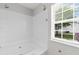 Modern bathroom with a large soaking tub, shower, shelving, and a bright window at 408 Chesterfield Ct., Myrtle Beach, SC 29577