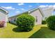 The side of this home features manicured shrubs and vinyl siding at 408 Chesterfield Ct., Myrtle Beach, SC 29577