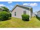 The side of this home features manicured shrubs and vinyl siding at 408 Chesterfield Ct., Myrtle Beach, SC 29577