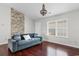 Inviting living room with brick accent wall, hardwood floors, and a comfortable sofa at 408 Chesterfield Ct., Myrtle Beach, SC 29577