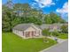 Aerial view of a home with well-manicured lawn, complemented by mature trees in a suburban setting at 409 Hunley Ln., Myrtle Beach, SC 29577
