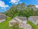 Aerial view of a charming home with a well-kept lawn, nestled within a lush, tree-filled neighborhood at 409 Hunley Ln., Myrtle Beach, SC 29577