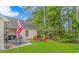 Lush backyard with a patio dining area and a fire pit, ideal for outdoor gatherings and enjoying the serene surroundings at 409 Hunley Ln., Myrtle Beach, SC 29577