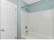 Bathroom showcasing a shower and tub combo with white tile and a door to the side at 409 Hunley Ln., Myrtle Beach, SC 29577