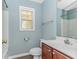 Bathroom featuring a vanity with storage, a mirror, and a window for natural light at 409 Hunley Ln., Myrtle Beach, SC 29577