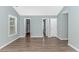 Spacious bedroom with wood-look floors and a large window offering plenty of sunlight at 409 Hunley Ln., Myrtle Beach, SC 29577
