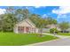 Attractive single-story home boasting a lush green lawn, colorful front flower garden, and mature shade trees at 409 Hunley Ln., Myrtle Beach, SC 29577