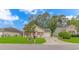 Inviting single-story home with manicured lawn and a private driveway, surrounded by mature trees at 409 Hunley Ln., Myrtle Beach, SC 29577