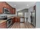 Modern kitchen boasting stainless steel appliances, wooden cabinets and laminate flooring that flows into the dining area at 409 Hunley Ln., Myrtle Beach, SC 29577