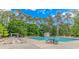 Community swimming pool with lounge chairs and trees around the perimeter at 409 Hunley Ln., Myrtle Beach, SC 29577