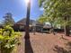 Serene backyard featuring mature trees, a screened-in porch, and established landscaping at 4266 Arabella Way, Little River, SC 29566
