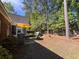 Private backyard oasis with mature trees, patio area, grill, and partial fence at 4266 Arabella Way, Little River, SC 29566