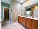 Bathroom featuring double vanity sinks, neutral paint, a tiled floor, and a private toilet area at 4266 Arabella Way, Little River, SC 29566