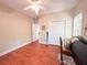 Bright bedroom with hardwood floors, ceiling fan, closet, and ample natural light at 4266 Arabella Way, Little River, SC 29566