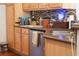 Shows a kitchen with wood cabinets, granite countertops, and stainless steel appliances at 4266 Arabella Way, Little River, SC 29566