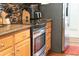 Shows the kitchen with stainless steel appliances, wood cabinets, and mosaic tile backsplash at 4266 Arabella Way, Little River, SC 29566