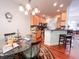 Eat-in kitchen features wood cabinets, stainless appliances, granite counters, and eat-in breakfast bar at 4266 Arabella Way, Little River, SC 29566