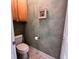 Cozy powder room features a toilet and wall-mounted cabinet in neutral tones at 4266 Arabella Way, Little River, SC 29566
