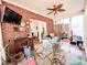 Charming sunroom with brick walls, ceiling fan, and cozy seating area, perfect for relaxing and enjoying natural light at 4266 Arabella Way, Little River, SC 29566