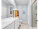 Modern bathroom featuring a double sink vanity, shower, and storage shelving at 4698 Cloisters Ln., Myrtle Beach, SC 29577