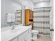 Bright bathroom featuring a modern vanity, ample storage, and a shower with black and white curtains at 4698 Cloisters Ln., Myrtle Beach, SC 29577
