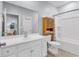 Bright bathroom with a white vanity, sink, toilet, bathtub, and a storage cabinet for towels and toiletries at 4698 Cloisters Ln., Myrtle Beach, SC 29577