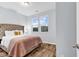 Comfortable bedroom featuring a tufted headboard, stylish bedding, and natural light at 4698 Cloisters Ln., Myrtle Beach, SC 29577