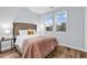 Comfortable bedroom featuring a tufted headboard, stylish bedding, and natural light at 4698 Cloisters Ln., Myrtle Beach, SC 29577