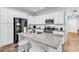 Kitchen featuring white cabinets, stainless steel appliances, granite countertops, and hardwood flooring at 4698 Cloisters Ln., Myrtle Beach, SC 29577