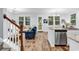 Open-concept living space with modern furnishings, hardwood floors, and staircase with access to additional living spaces at 4698 Cloisters Ln., Myrtle Beach, SC 29577