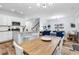 Open-concept living space featuring a dining table, kitchen island, modern finishes, and seating area at 4698 Cloisters Ln., Myrtle Beach, SC 29577