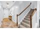 Hallway featuring neutral walls, hardwood floors, and carpeted stairway access at 4698 Cloisters Ln., Myrtle Beach, SC 29577