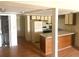 Kitchen view with white appliances and wooden cabinets, plus view of laundry area at 500 Fairway Village Dr. # 6E, Myrtle Beach, SC 29588