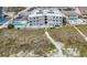 Aerial view of beachfront condos with a pool, sandy paths, and lush vegetation at 5000 N Ocean Blvd. # F2, North Myrtle Beach, SC 29582