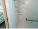 This renovated bathroom features an elegant glass enclosed shower with modern white and marble tiling at 5000 N Ocean Blvd. # F2, North Myrtle Beach, SC 29582