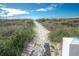 Sandy beach path lined with dune grass leads to a pristine beach at 5000 N Ocean Blvd. # F2, North Myrtle Beach, SC 29582