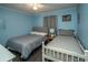 Light filled bedroom with two beds, blue walls and wood look flooring at 5000 N Ocean Blvd. # F2, North Myrtle Beach, SC 29582