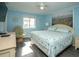 Light and airy bedroom features calming blue walls, beachy decor, and a cozy egg chair at 5000 N Ocean Blvd. # F2, North Myrtle Beach, SC 29582