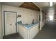 Hallway leading to unit featuring neutral carpet, blue trim, and wooden ceilings at 5000 N Ocean Blvd. # F2, North Myrtle Beach, SC 29582