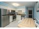 Bright kitchen with stainless steel appliances, light blue walls, white cabinets, and a wooden table with seating at 5000 N Ocean Blvd. # F2, North Myrtle Beach, SC 29582