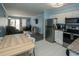 Modern living area with a wooden dining table, stainless steel appliances, and a cozy sitting area with comfortable furniture at 5000 N Ocean Blvd. # F2, North Myrtle Beach, SC 29582