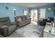 Comfortable living room with a couch, armchair, and sliding door to a balcony, perfect for relaxation at 5000 N Ocean Blvd. # F2, North Myrtle Beach, SC 29582