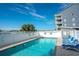Community pool with chairs and a privacy fence at 5000 N Ocean Blvd. # F2, North Myrtle Beach, SC 29582