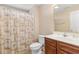 Bathroom featuring palm tree shower curtain, tile flooring and a sink with wooden cabinets at 509 Fallen Leaf Ct., Myrtle Beach, SC 29588